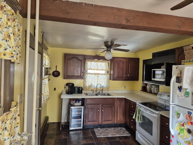 kitchen featuring white appliances, beverage cooler, beamed ceiling, light countertops, and a sink