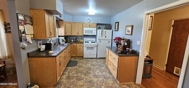 kitchen featuring white appliances and sink