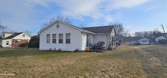 view of side of home with a yard