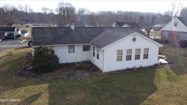 rear view of house with a yard