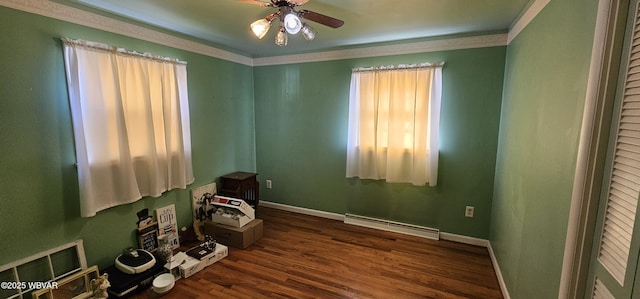 interior space with ornamental molding, dark wood-type flooring, ceiling fan, and baseboard heating