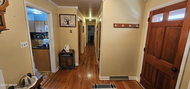 foyer with crown molding and dark hardwood / wood-style flooring