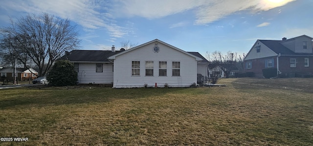 back of property featuring a lawn