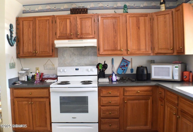 kitchen with backsplash and white appliances