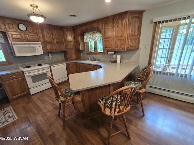 4401 Pine Mountain Rd, Jersey Shore, PA 17740 - kitchen featuring white appliances, a baseboard radiator, a kitchen breakfast bar, brown cabinetry, and dark wood-style floors
