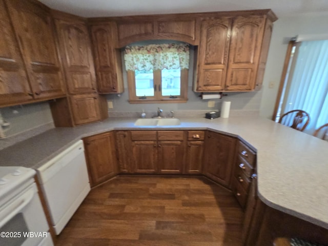4401 Pine Mountain Rd, Jersey Shore, PA 17740 - kitchen with range, dark wood-type flooring, light countertops, brown cabinets, and a peninsula