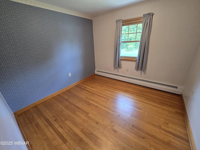 4401 Pine Mountain Rd, Jersey Shore, PA 17740 - unfurnished room featuring a baseboard heating unit, wood finished floors, and wallpapered walls