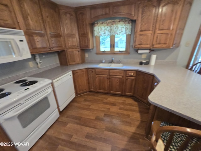 4401 Pine Mountain Rd, Jersey Shore, PA 17740 - kitchen featuring white appliances, dark wood-style flooring, light countertops, and brown cabinets