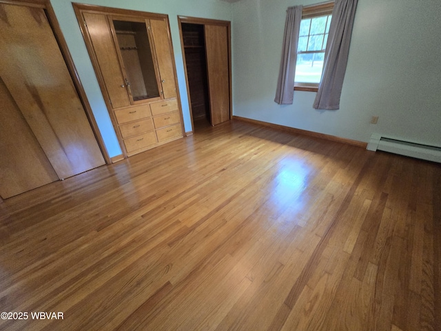 4401 Pine Mountain Rd, Jersey Shore, PA 17740 - unfurnished bedroom with a baseboard radiator, wood finished floors, and multiple closets