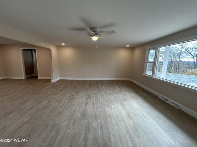 empty room featuring hardwood / wood-style floors and ceiling fan