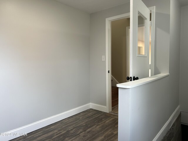 hallway with dark hardwood / wood-style floors