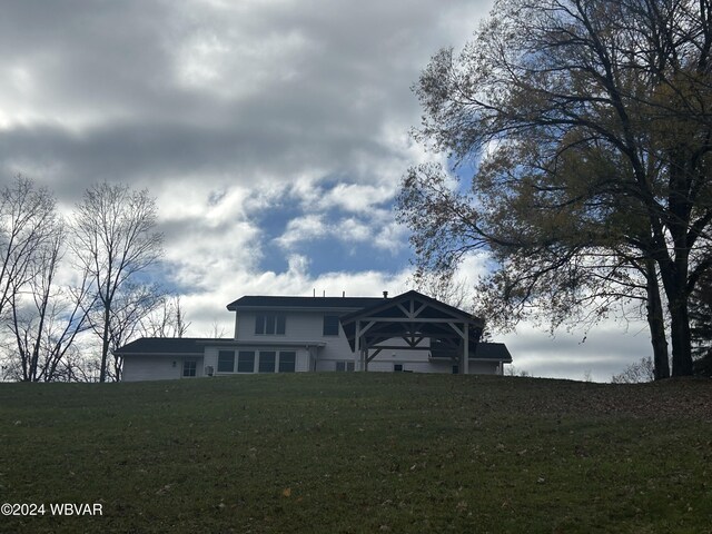 rear view of property with a yard