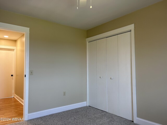 unfurnished bedroom featuring carpet floors and a closet