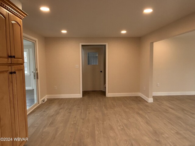 spare room with light hardwood / wood-style flooring