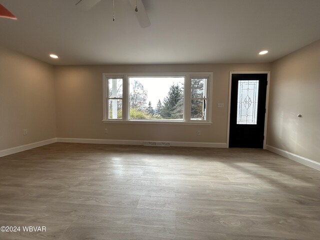 foyer entrance featuring ceiling fan and light hardwood / wood-style floors