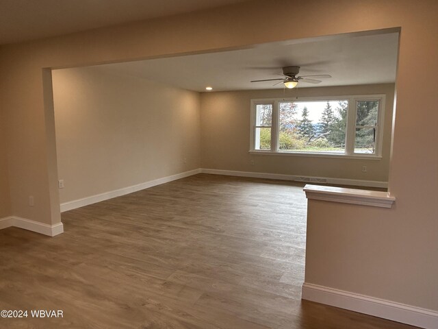 spare room with hardwood / wood-style flooring and ceiling fan