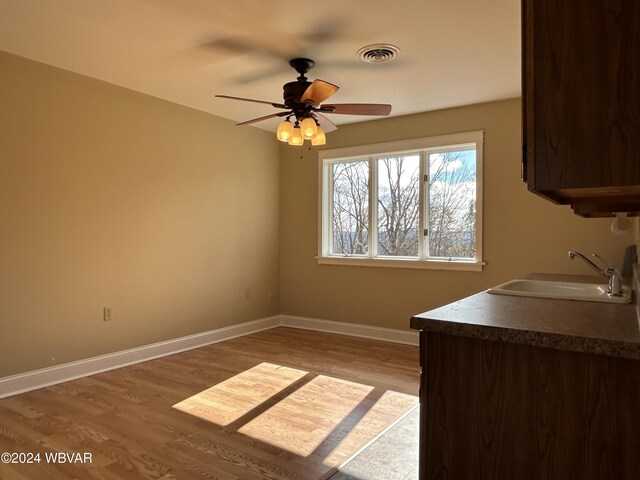 interior space featuring ceiling fan, sink, and hardwood / wood-style floors