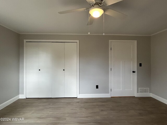 unfurnished bedroom with hardwood / wood-style flooring, ceiling fan, ornamental molding, and a closet