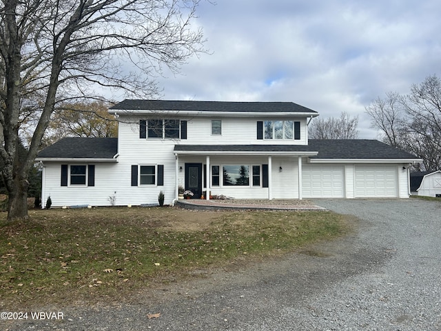 front of property with a garage and a front lawn