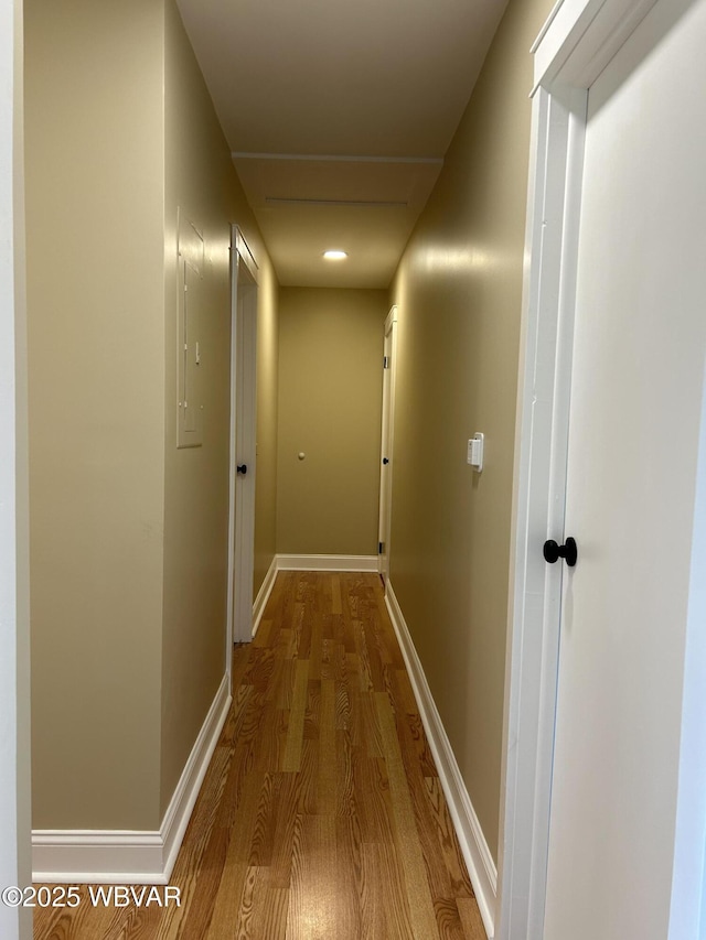 corridor with hardwood / wood-style flooring