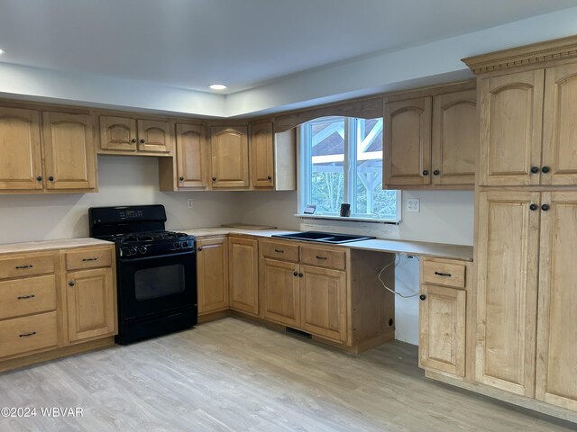 kitchen with black gas range oven, sink, and light hardwood / wood-style floors