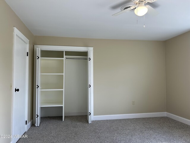 unfurnished bedroom featuring ceiling fan, carpet floors, and a closet