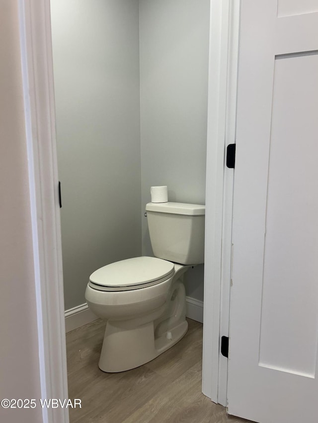 bathroom with toilet and hardwood / wood-style floors