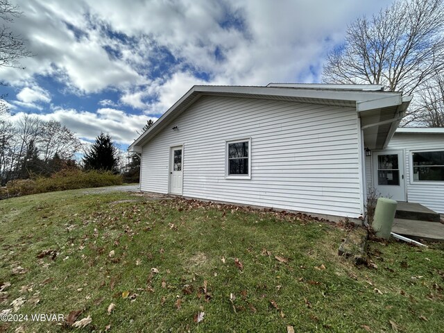 view of side of home featuring a yard