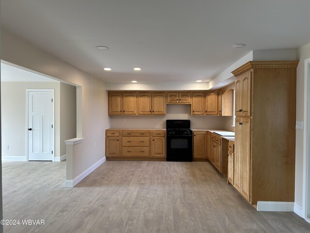 kitchen featuring black range with gas stovetop and light wood-type flooring