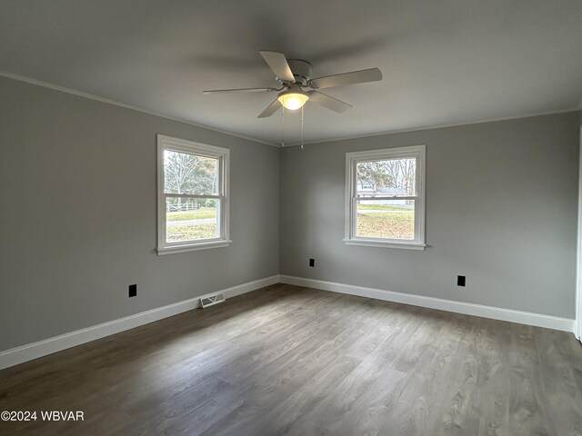 unfurnished room with crown molding, ceiling fan, wood-type flooring, and a wealth of natural light