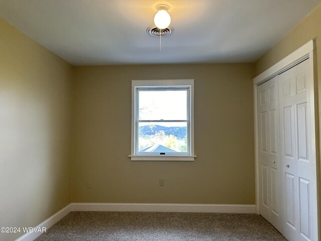 unfurnished bedroom featuring a closet and carpet