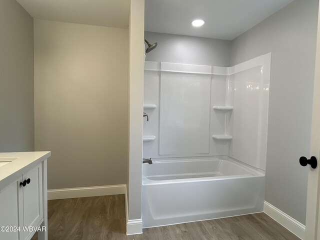 bathroom with vanity, hardwood / wood-style flooring, and  shower combination