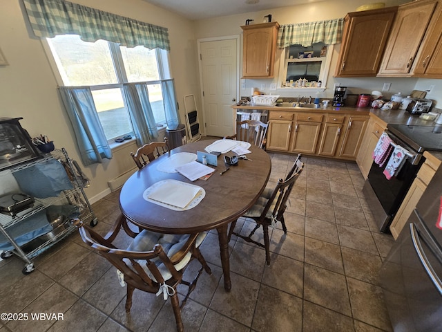 tiled dining room featuring sink