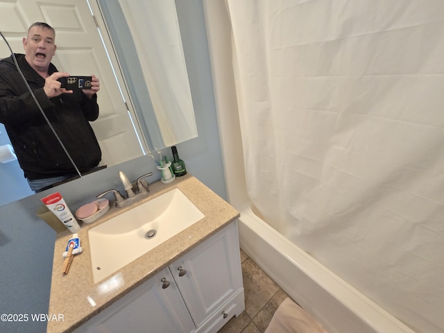 bathroom featuring tile patterned flooring, vanity, and shower / tub combo with curtain