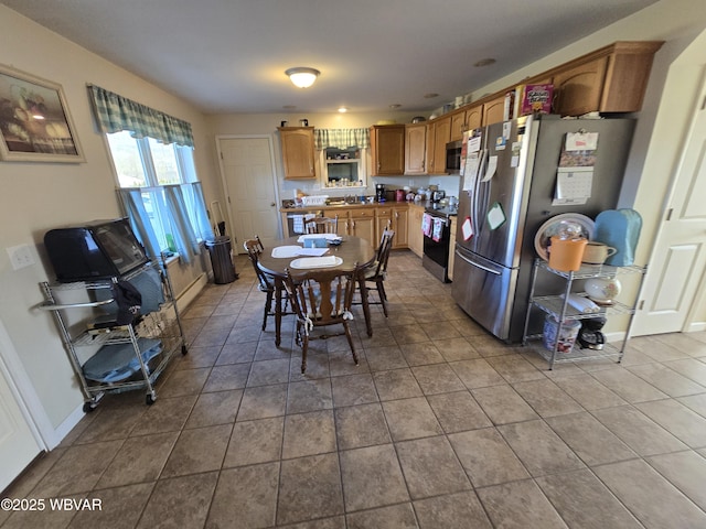 kitchen featuring appliances with stainless steel finishes, tile patterned flooring, and sink