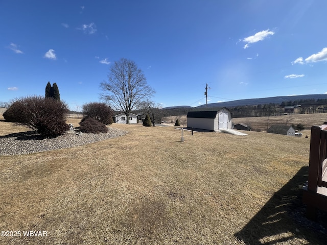 view of yard with an outdoor structure and a shed