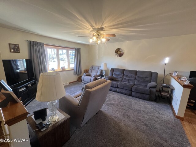 living area featuring baseboards and visible vents