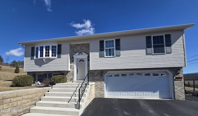 bi-level home with driveway and a garage