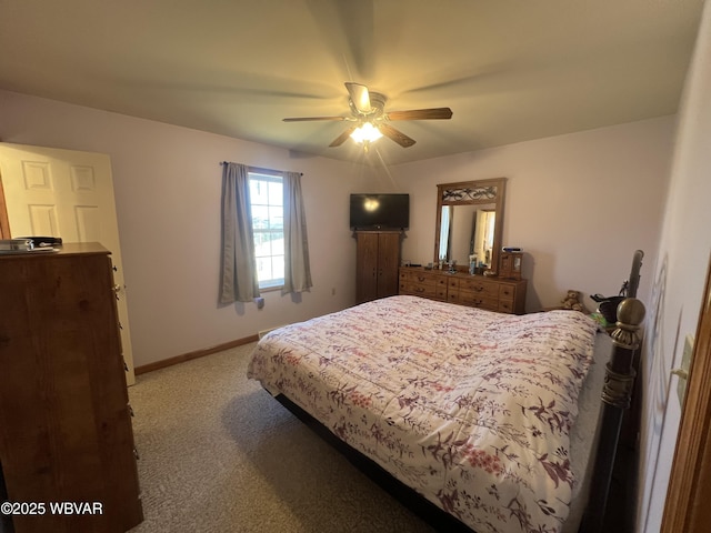 carpeted bedroom with ceiling fan and baseboards