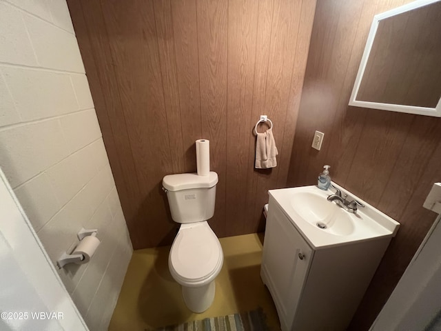 half bath featuring toilet and vanity