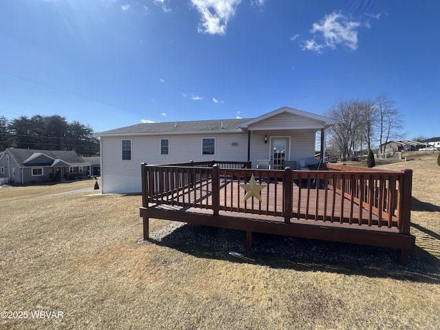 rear view of property featuring a deck