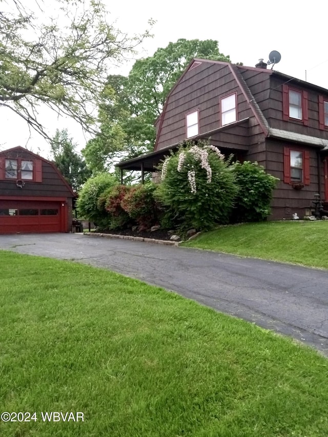 view of property exterior with a garage and a yard