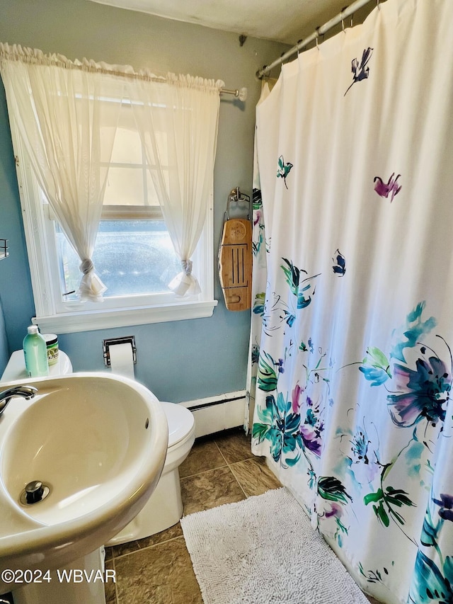 bathroom with sink, toilet, tile patterned floors, and a baseboard radiator