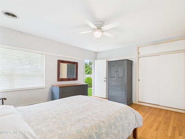 bedroom with light wood-style flooring and ceiling fan