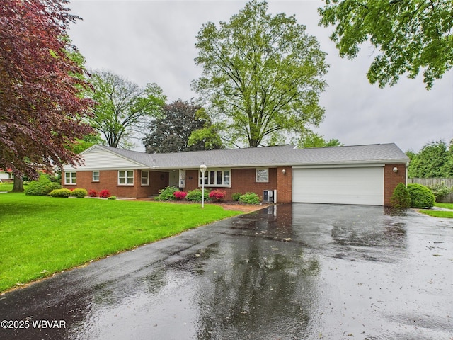 ranch-style home with brick siding, an attached garage, and asphalt driveway