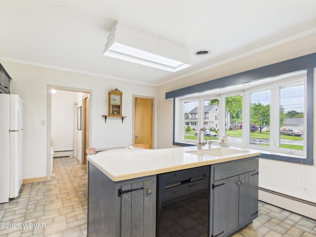 kitchen with baseboard heating, freestanding refrigerator, black dishwasher, a sink, and crown molding