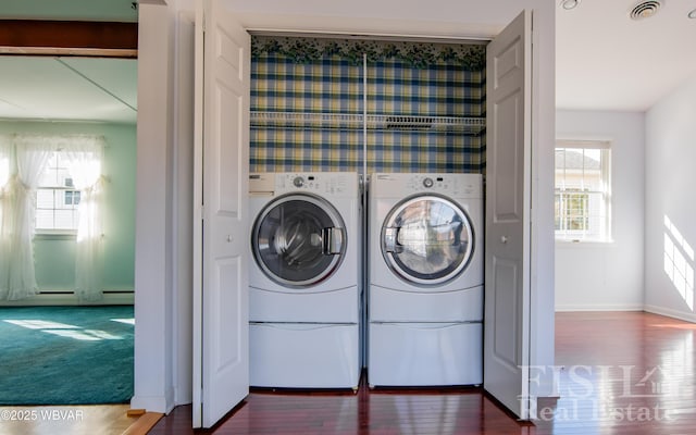 laundry area with laundry area, plenty of natural light, washing machine and clothes dryer, and visible vents