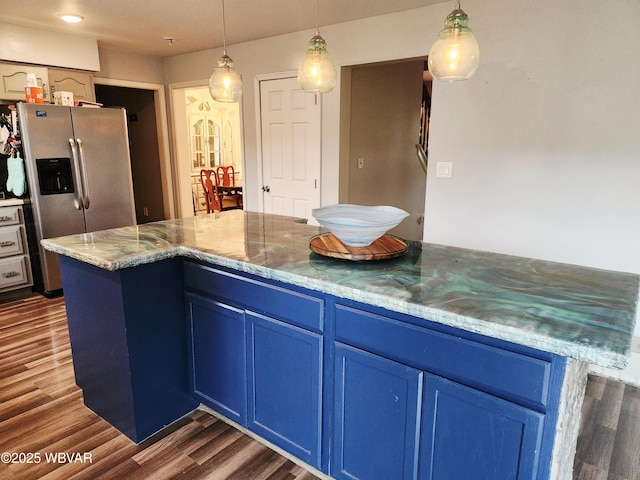 59 Keyser Cir, Williamsport, PA 17701 - kitchen with stainless steel fridge, blue cabinets, dark wood finished floors, hanging light fixtures, and light stone counters
