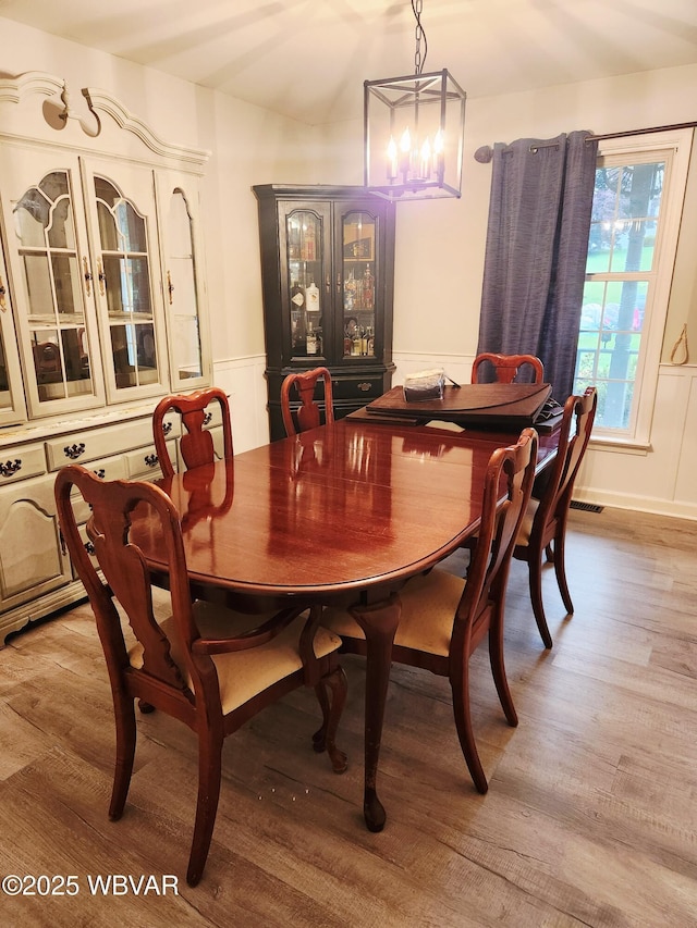 59 Keyser Cir, Williamsport, PA 17701 - dining room featuring light wood-style flooring, a chandelier, and wainscoting