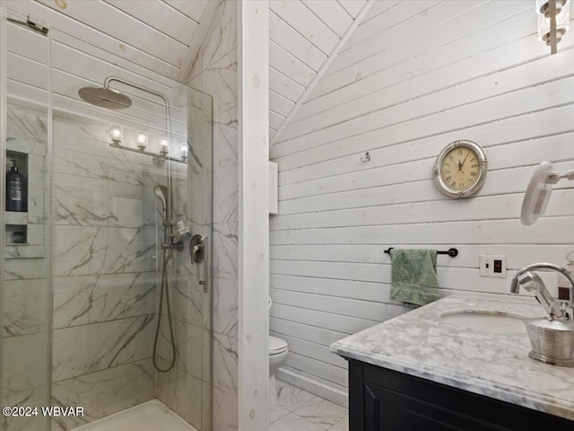 bathroom with vanity, vaulted ceiling, tiled shower, toilet, and wood walls